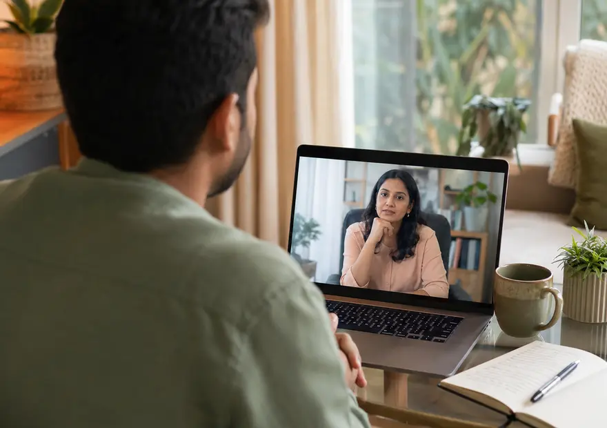 Adult attending an online emotional regulation counselling session with a psychologist